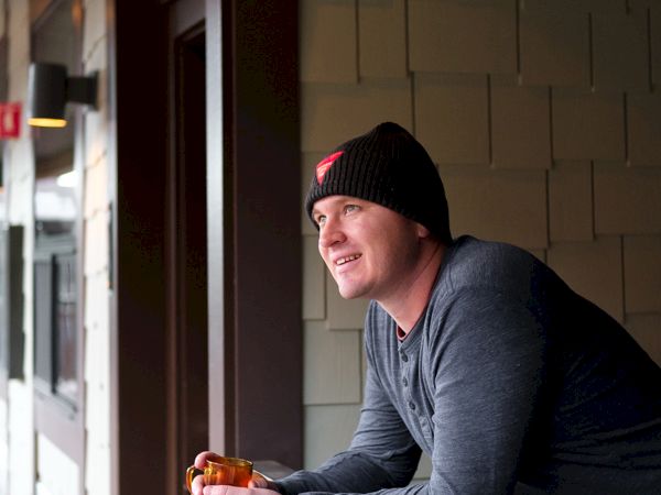 Man on balcony with coffee