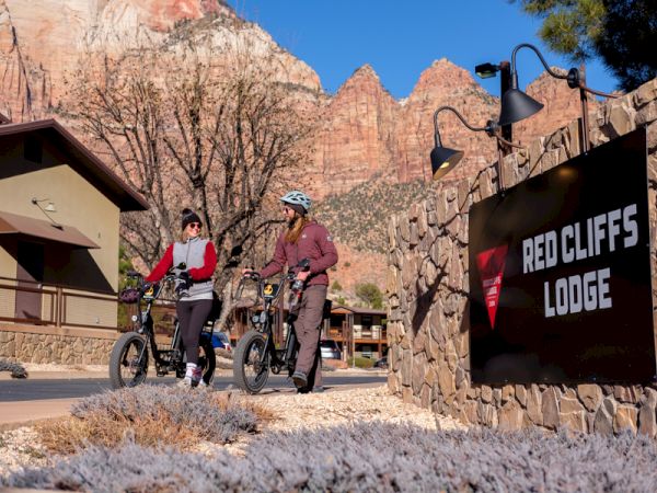 Couple walks their bikes in Springdale Utah