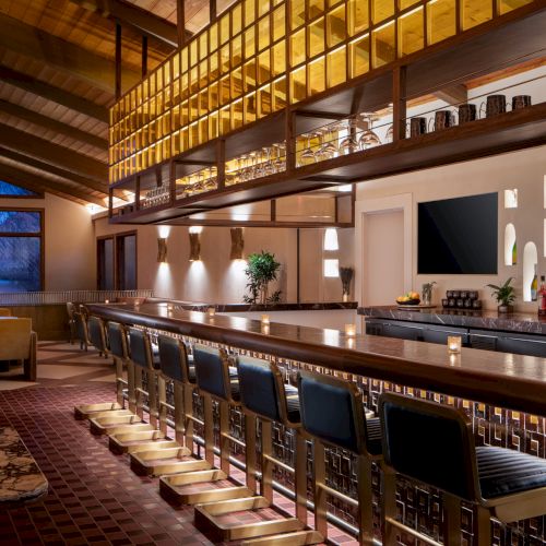 A cozy cafe or bar with warm lighting, wooden shelves, a long counter, vintage decor, and a few stools, inviting and intimate.