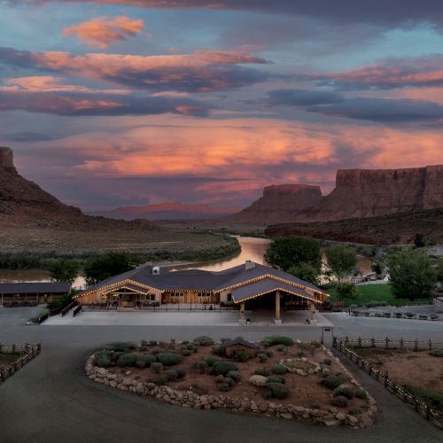 A desert canyon at dusk with layered cliffs, a winding river, and a pink-orange sky. Top it at 140 characters, always ending the sentence.